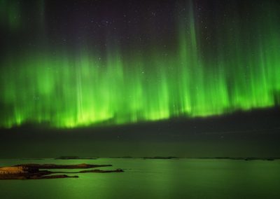 Green Northern lights dancing over lake Thingvallavatn at Þingvellir National Park