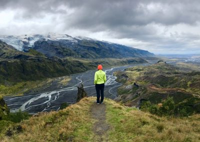 Hiker overlooking Thormork with Eyjafjallajokull in clouds