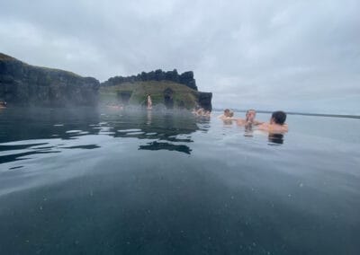 People enjoying the spa treatment at the warm geothermal Sky Lagoon spa in Iceland